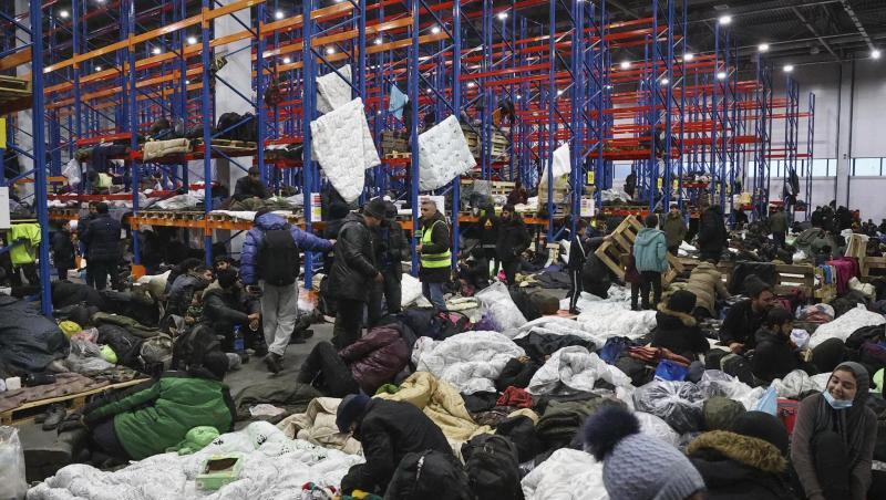 Migranten, die sich für die Nacht im Logistikzentrum am Kontrollpunkt "Kuznica" an der belarussisch-polnischen Grenze einrichten. Migranten, die sich für die Nacht im Logistikzentrum am Kontrollpunkt "Kuznica" an der belarussisch-polnischen Grenze einrichten.