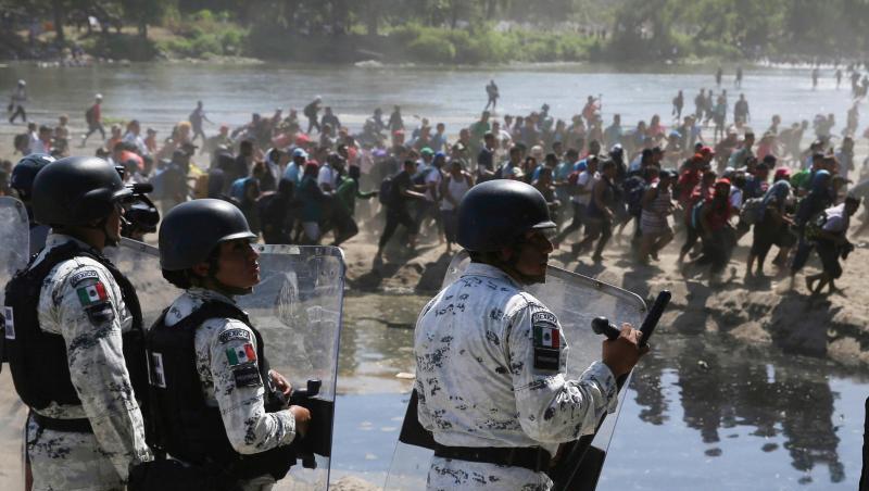 Migranten passieren mexikanischen Nationalgardisten am Grenzfluss Río Suchiate zwischen zwischen Guatemala und Mexiko. Migranten passieren mexikanischen Nationalgardisten am Grenzfluss Río Suchiate zwischen zwischen Guatemala und Mexiko.