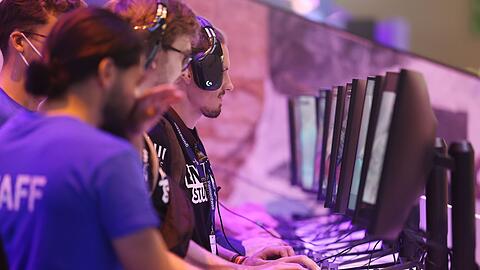 Messebesucher testen ein Computerspiel bei der Gamescom 2022.