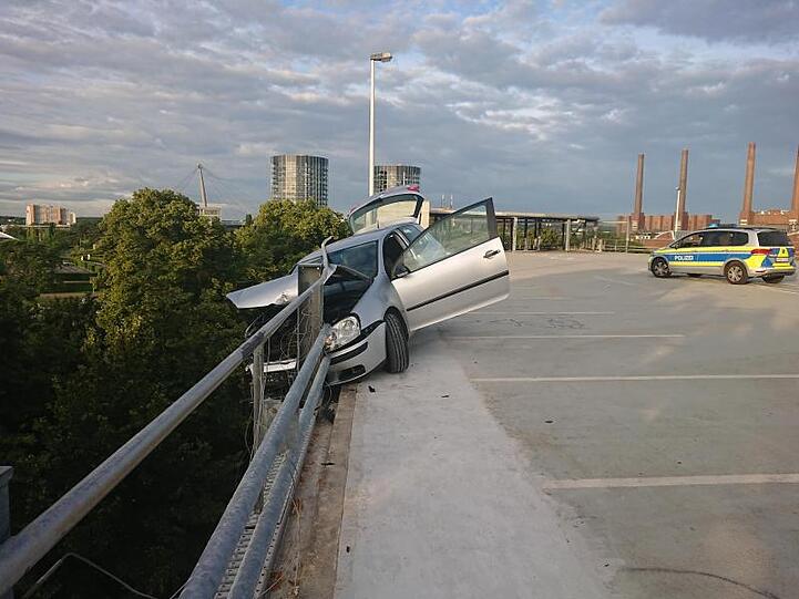 Das Auto hängt in der Sicherungsplanke auf einem Parkhausdeck in Wolfsburg.