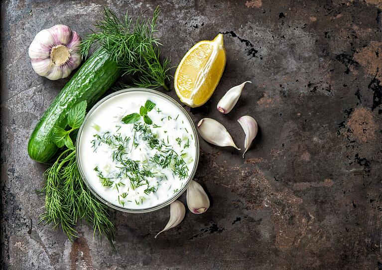 F&uuml;r das Dressing verr&uuml;hren Sie 300 Gramm griechischen Joghurt mit einer fein gehackten Knoblauchzehe, dem Saft einer halben Zitrone, einem Essl&ouml;ffel Oliven&ouml;l und etwas Pfeffer. Anschlie&szlig;end mischen Sie zwei Essl&ouml;ffel frisch gehackten Dill unter die Joghurtcreme und geben das Dressing zu den Gurken. Vor dem Servieren den Salat f&uuml;r rund 30 Minuten im K&uuml;hlschrank ziehen lassen.