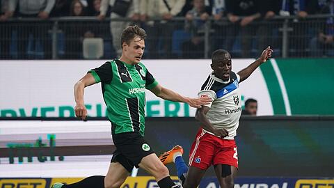 Fürths Max Christiansen (l) und Hamburgs Jean-Luc Dompe kämpfen um den Ball.