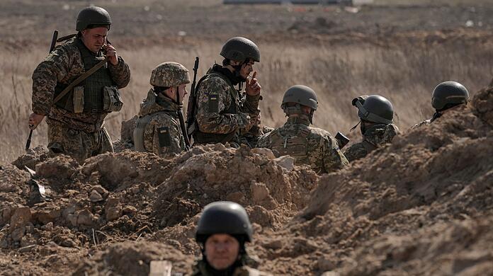 Ukrainische Soldaten stehen in Schützengräben nördlich von Kiew.