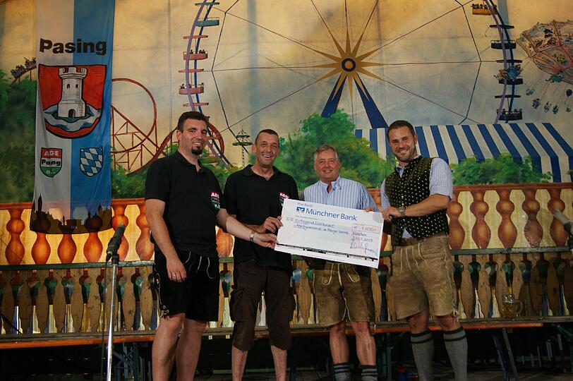 Feierliche Spendenübergabe im Rahmen der Pasinger Vorwiesn (v. l.): Peter Denk und Anton Hinkofer, Vorstände der ARGE Pasing e.V., sowie Hans-Georg Lutz, VIP-Kundenbetreuer der Münchner Bank, und Stefan Holzer, Leiter der Münchner Bank-Geschäftsstelle in Pasing.