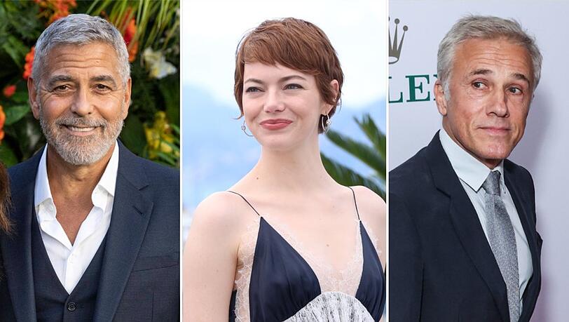 George Clooney (l.), Emma Stone und Christoph Waltz befinden sich 2025 allesamt im Wettbewerb um den Goldenen Löwen von Venedig.