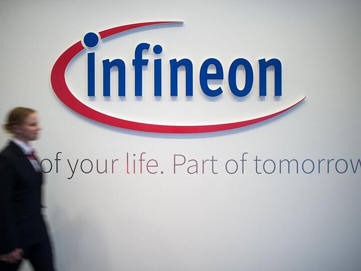 Frau geht an Infineon-Logo vorbei. Foto: Matthias Balk/Archivbild