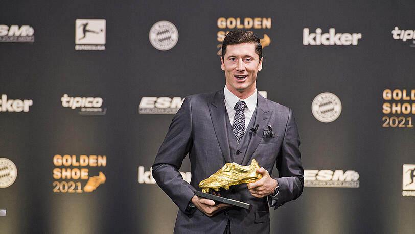 Darf sich geehrt fühlen: Robert Lewandowski vom FC Bayern mit der Trophäe "Goldener Schuh 2021".