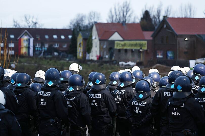 Polizisten am Rande des besetzten Braunkohleorts Lützerath.