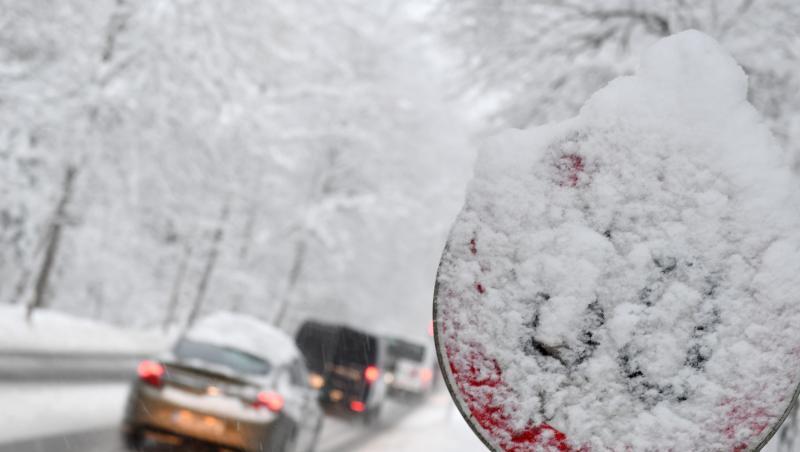 Autos fahren auf einer verschneiten Straße in Berchtesgaden (Bayern). Foto: Tobias Hase/Archiv