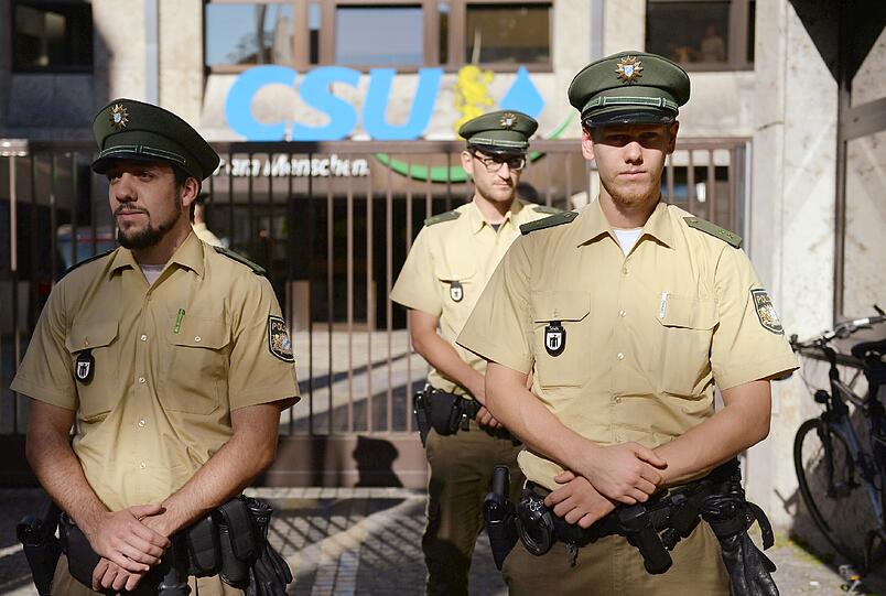 Münchner Polizisten vor der CSU-Zentrale. Mit der Regierungspartei gibt es Streit um Zuschüsse in der teuren Landeshauptstadt. Foto: Andreas Gebert