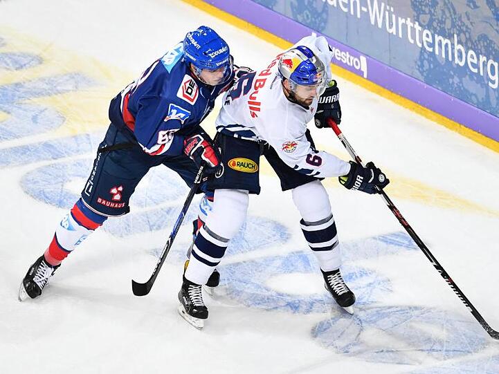 Mannheims Alex Lambacher (l) und Münchens Daryl Boyle kämpfen um den Puck. Foto: Uwe Anspach/Archiv