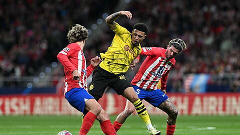 Jadon Sancho (M.) wird gleich von zwei Atlético-Profis angegriffen.