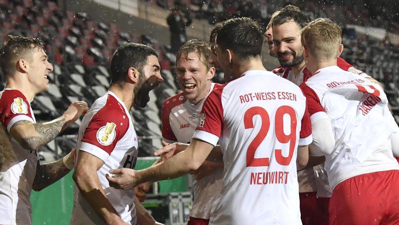 Die Spieler von Rot-Weiss Essen feiern Oguzhan Kefkir (2.v.l) nach seinem Tor gegen Leverkusen.