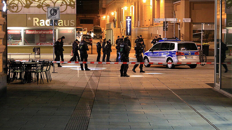 Polizisten durchsuchen am Mittwochabend eine Straße nahe des Erfurter Hauptbahnhofs.