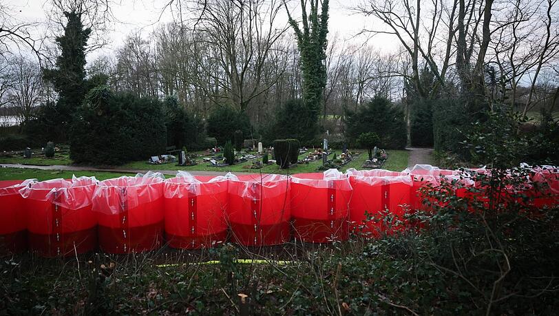 Rote Fässer voller Wasser: Der mobile Deich soll den Parkfriedhof Bümmerstede schützen.