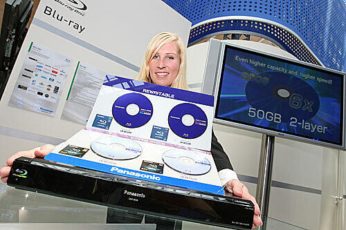 Eine Hostess präsentiert verschiedene Blu-ray-Discs.