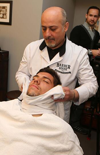 Löwen-Keeper Stefan Ortega auf derm Barber-Stuhl. AZ-Reporter Marc Merten (Hintergrund) ist mit dabei.
