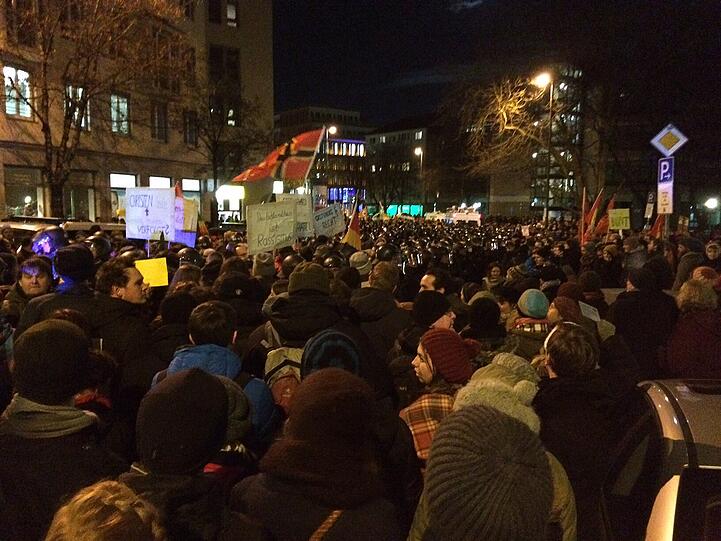 Immer noch Stillstand am OberAnger. Der Demonstrationszug steckt fest. In der Mitte sind die Mügida-Anhänger, umringt von wenigen Polizisten und unzähligen Gegendemonstranten.