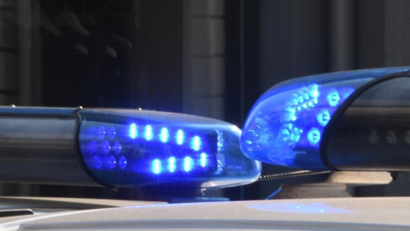 Polizeifahrzeuge stehen mit eingeschaltetem Blaulicht. Polizeifahrzeuge stehen mit eingeschaltetem Blaulicht.