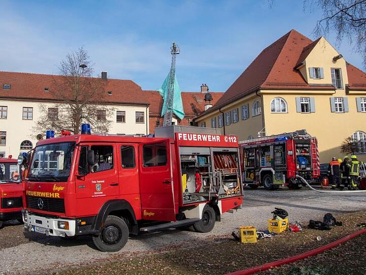 Feuerwehrfahrzeuge stehen vor dem alten Schloss. Foto: Stefan Puchner/Archiv