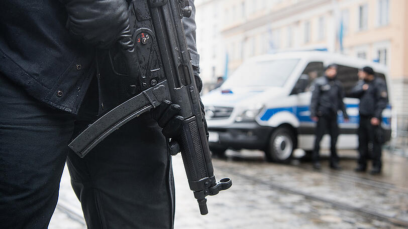 Eine Polizistin sichert mit einer Maschinenpistole vom Typ Heckler & Koch MP5 den Bereich vor dem Bayerischen Hof.