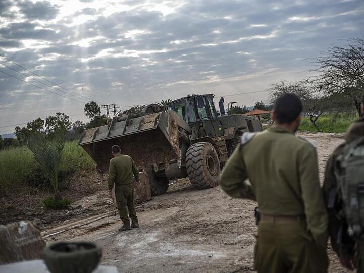 Israelische Soldaten beobachten die Aufräumarbeiten mit einem Bulldozer nach Raketenangriffen aus den Palästinensischen Autonomiegebieten.