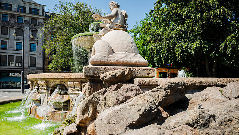 Hier am Wittelsbacher Brunnen hat sich seit einigen Jahren ein kleiner Pumuckl aus Bronze versteckt. K&ouml;nnen Sie ihn entdecken?