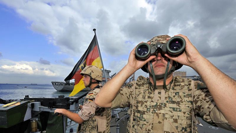 Deutsche Marine-Soldaten halten an Bord der Fregatte "Karlsruhe" an einem Maschinengewehr Wache. Deutsche Marine-Soldaten halten an Bord der Fregatte "Karlsruhe" an einem Maschinengewehr Wache.