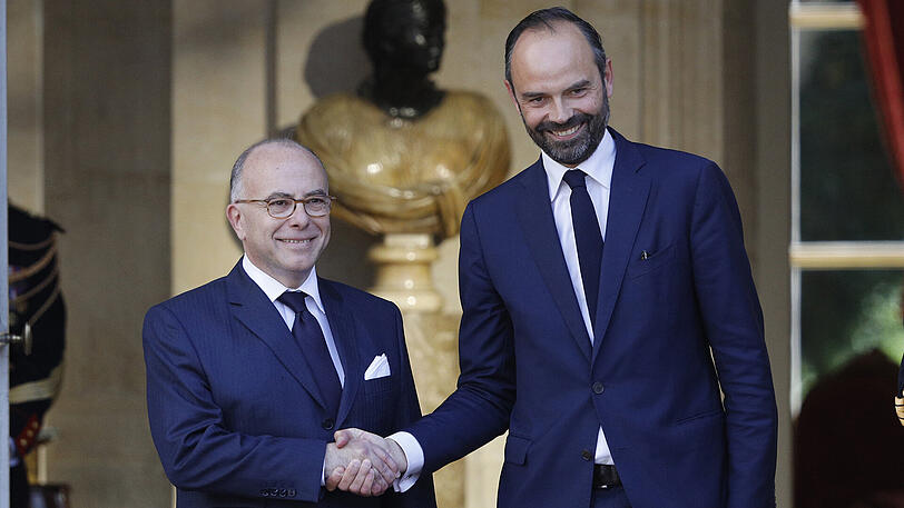 Der neu ernannte französische Premierminister Edouard Philippe wird von seinem Vorgänger, Bernard Cazeneuve (l), in Paris (Frankreich) begrüßt.
