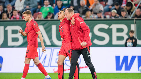 Jamal Musiala  wird verletzt vom Platz geführt.