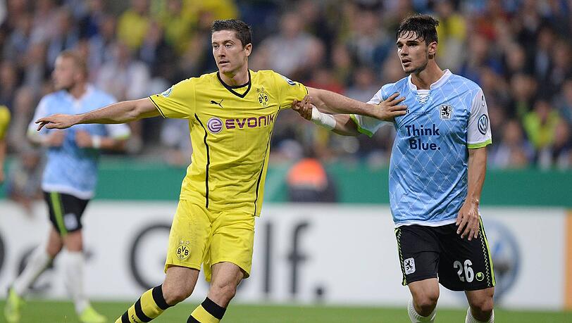 Der TSV 1860 um Christopher Schindler schied 2013 gegen Borussia Dortmund um Robert Lewandowski aus. Der TSV 1860 um Christopher Schindler schied 2013 gegen Borussia Dortmund um Robert Lewandowski aus.