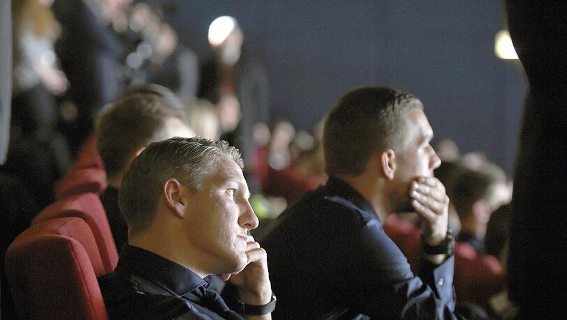 Die Spieler Bastian Schweinsteiger (l) und Lukas Podolski sitzen am 10.11.2014 in Berlin bei der Weltpremiere des Films "Die Mannschaft" im Kino Cinestar im Sony Center am Potsdamer Platz. Der Film ist eine offizielle Dokumentation der FIFA-Fußball-Weltmeisterschaft in Brasilien 2014. Die Spieler Bastian Schweinsteiger (l) und Lukas Podolski sitzen am 10.11.2014 in Berlin bei der Weltpremiere des Films "Die Mannschaft" im Kino Cinestar im Sony Center am Potsdamer Platz. Der Film ist eine offizielle Dokumentation der FIFA-Fußball-Weltmeisterschaft in Brasilien 2014.