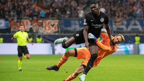Frankfurts Randal Kolo Muani (l) prallt gegen Marseilles Torwärter Pau Lopez.