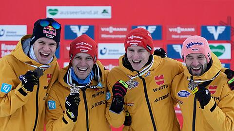 Die deutschen Skiflieger Andreas Wellinger (l-r), Stephan Leyhe, Karl Geiger und Pius Paschke freuen sich über die Bronzemedaille.