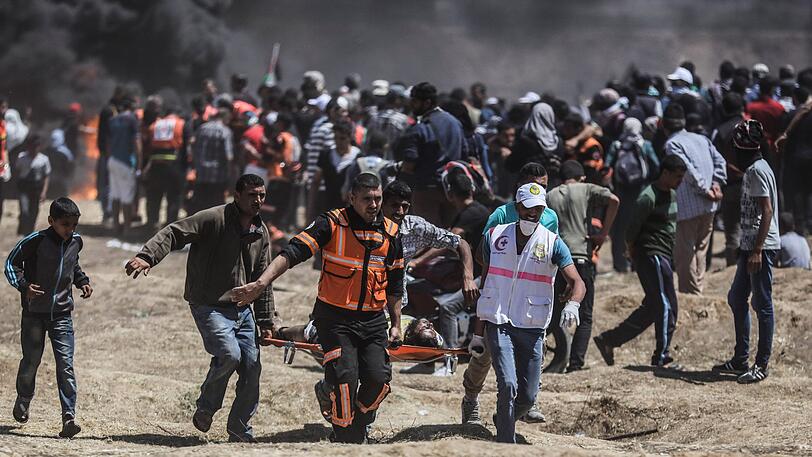 Palästinenser evakuieren einen Mann, der bei Auseinandersetzungen mit der israelischen Armee verletzt worden ist.