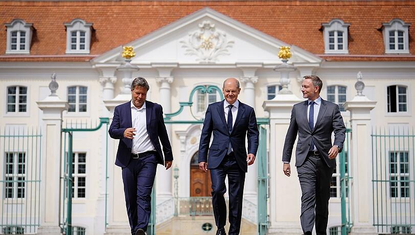 Kanzler Olaf Scholz (M), Wirtschaftsminister Robert Habeck (l) und Finanzminister Christian Lindner vor dem Schloss Meseberg.