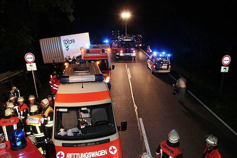 Warum ein aus München kommender Lkw am Montagabend auf der B12 nach rechts umkippt und seinen Fahrer einklemmt, ist nicht bekannt. Der Mann wird in ein Krankenhaus gebracht.