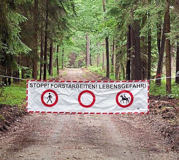 Achtung, Forstarbeiten: Warntransparent im Wald für Wanderer und Reiter. Achtung, Forstarbeiten: Warntransparent im Wald für Wanderer und Reiter.