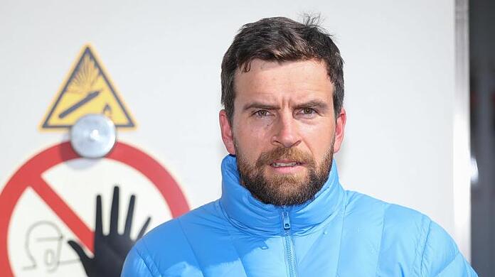 Der Extrem-Sportler Jonas Deichmann steht vor der Klimakammer der DB Systemtechnik.