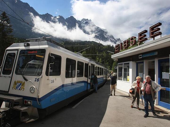 Ein Waggon der Zugspitzbahn am Bahnhof Eibsee vor der Kulisse der Zugspitze. Foto: Karl-Josef Hildenbrand/dpa/Archivbild