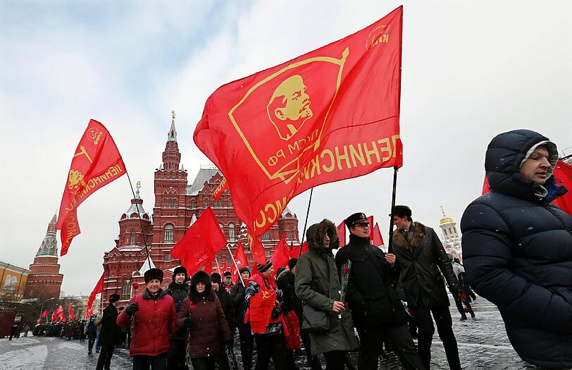 Am Donnerstag jährt sich zum 92. Mal der Todestag Lenins. Hier halten russische Verehrer seine Flagge während eines Gedenkmarsches hoch.