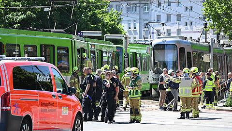 Einsatzkr&auml;fte von Polizei und Feuerwehr stehen nach einem Unfall neben zwei Stadtbahnen.