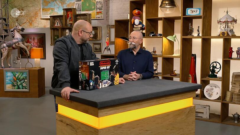 "Was ist das?", fragte Horst Lichter (rechts) in der Freitagsausgabe der ZDF-Trödelshow "Bares für Rares" etwas irritiert über das Nintendo Entertainment System in OVP. "Was ist das?", fragte Horst Lichter (rechts) in der Freitagsausgabe der ZDF-Trödelshow "Bares für Rares" etwas irritiert über das Nintendo Entertainment System in OVP.