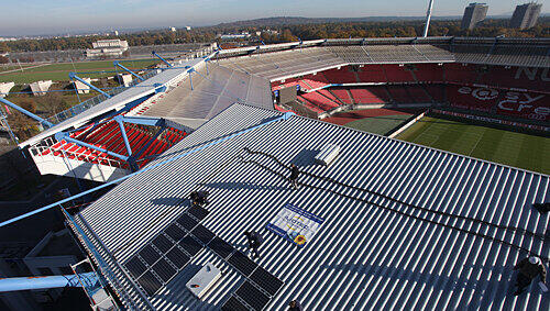 Die einzelnen Elemente der neuen Solar-Anlage werden jetzt auf dem Dach der Haupttribüne installiert: Noch bis Dezember laufen die Arbeiten, die den Energieverbrauch des Nürnberger easyCredit-Stadions auf ein umweltfreundliches Niveau bringt.