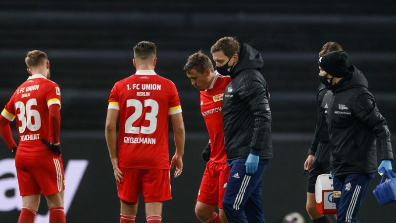 Unions Max Kruse (M) wird verletzt zur Seitenlinie geführt.