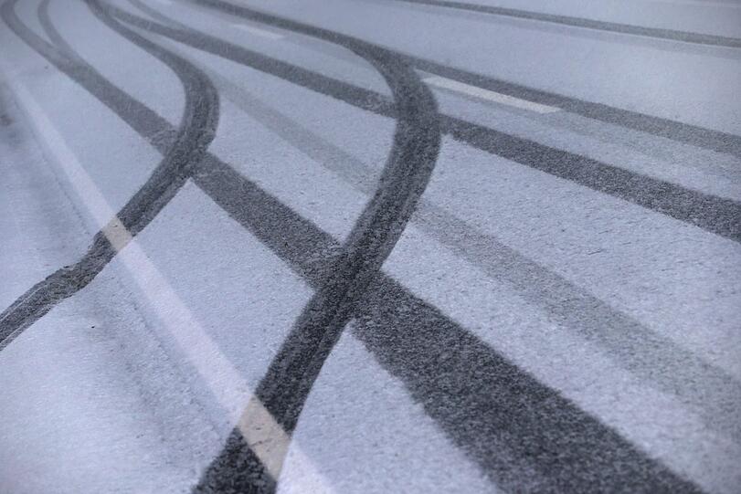 Reifenspuren auf einer verschneiten Straße im Allgäu. (Symbolbild)