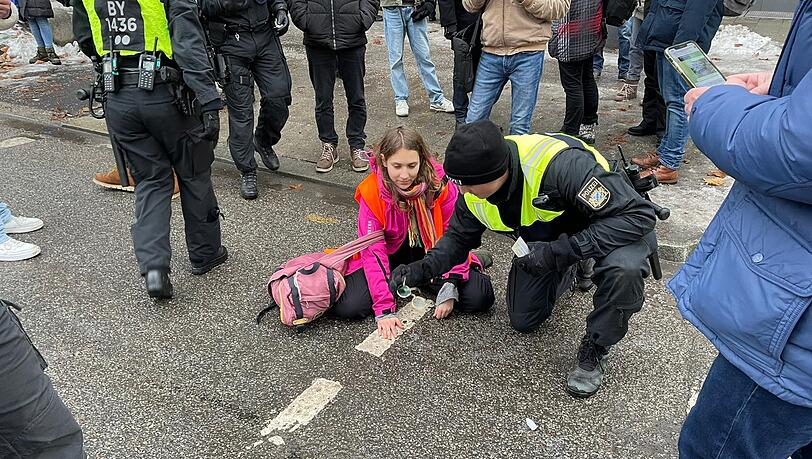 Trotz der Polizeipräsenz schaffte es eine dritte Aktivistin, sich auf der Straße festzukleben. Trotz der Polizeipräsenz schaffte es eine dritte Aktivistin, sich auf der Straße festzukleben.