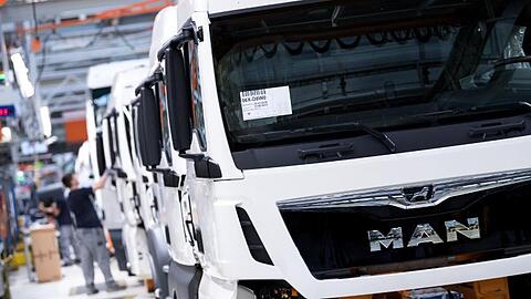 Mitarbeiter von MAN Truck & Bus arbeiten in der Produktionsstraße. MAN gehört zur VW-Tochter Traton.