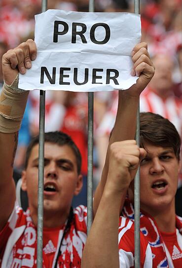 Das Lager ist gespalten: Auf der einen Seite Fans die "Pro Manuel Neuer"- Schilder in die Luft halten ...
