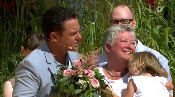 Stefan Mross überreicht Hebamme Monika einen Blumenstrauß.